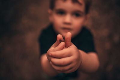 Close-up of baby boy. toddler with hands out in front offering. male baby. 