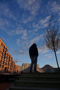 Low angle view of man standing against building