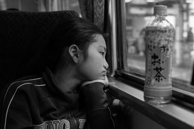 Girl looking through train window