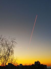 Low angle view of silhouette buildings against sky during sunset