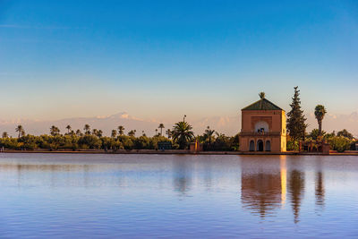 Scenic view of swimming pool by lake against sky