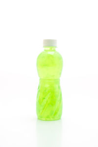 Close-up of green bottle against white background