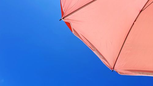 Low angle view of parasol against clear sky