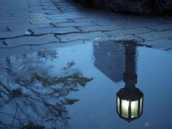 High angle view of illuminated street light by lake