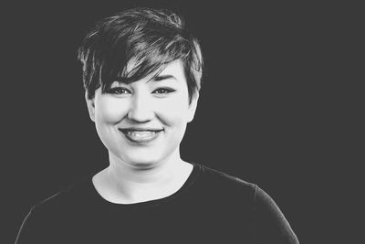 Portrait of young man against black background