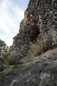 Low angle view of rocks against sky