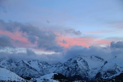 Scenic view of snowcapped mountains against sky during sunset