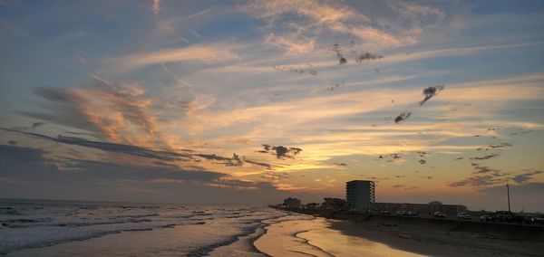 Scenic view of beach against sky during sunset