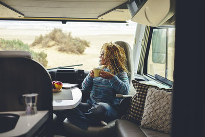 Woman looking away sitting in motor home