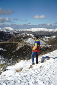 Rear view of woman standing on snow