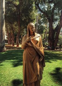 Portrait of young woman standing in park