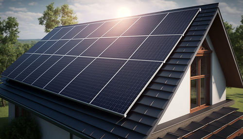 Historic farm house with modern solar panels on roof and wall