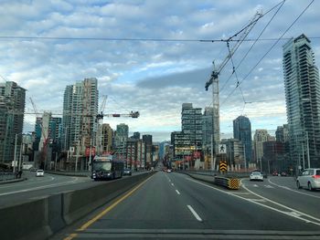 City street and buildings against sky