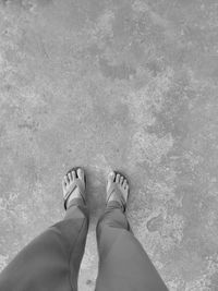 Low section of woman standing on ground