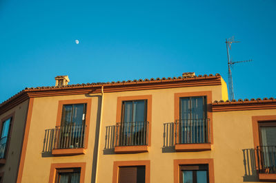 Low angle view of building against clear blue sky