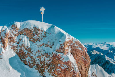 Scenic view of snowcapped mountains against blue sky