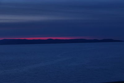 Scenic view of sea against romantic sky at sunset