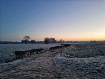 Scenic view of landscape against clear sky during winter