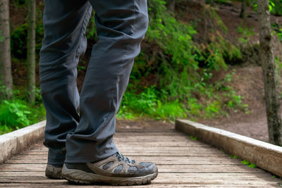 Low section of man standing on footpath