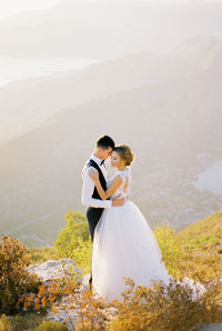 Rear view of woman standing on mountain