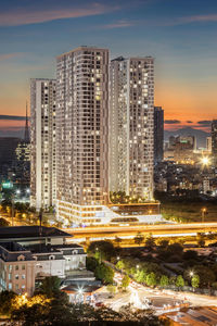 High angle view of illuminated buildings against sky at night