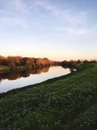 Scenic view of lake against sky at sunset