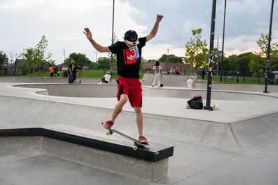 Rear view of man skateboarding on skateboard