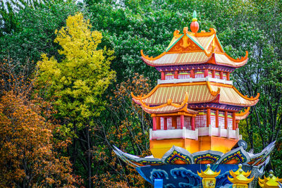 Temple against building and trees