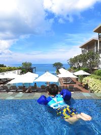 Rear view of man in swimming pool