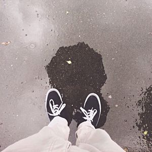 Low section of person standing in puddle