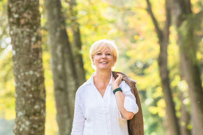 Portrait of a smiling young woman standing outdoors