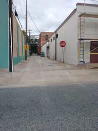 Road by building against sky in city