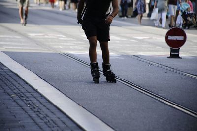 Low section of person skating on city street