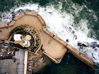 Aerial view of lighthouse by sea