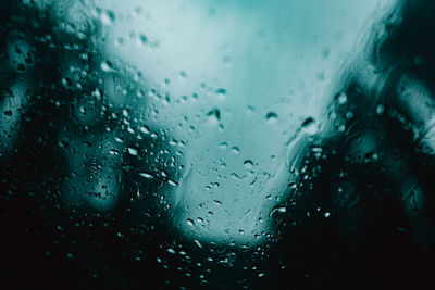 Full frame shot of wet glass window in rainy season