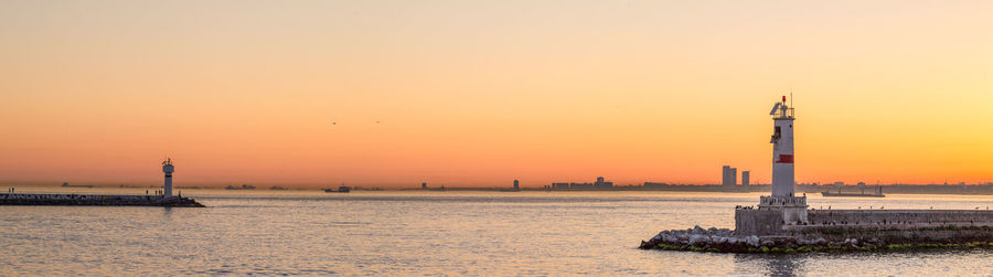 Panoramic view of lighthouses against clear sky at sunset