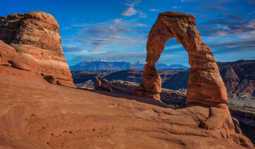 View of rock formation against cloudy sky