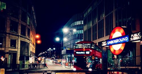 View of city street and buildings at night