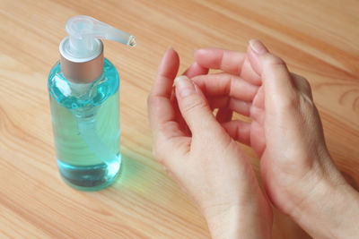 High angle view of person holding bottle