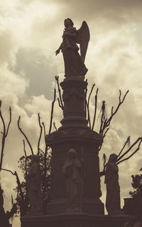 Low angle view of statue against sky in city