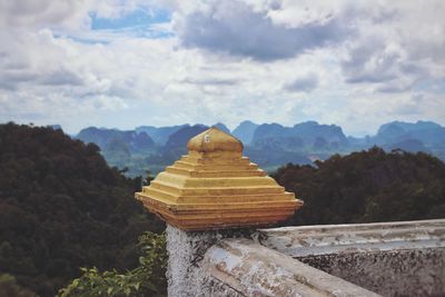 Scenic view of mountains against cloudy sky