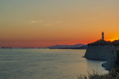 Scenic view of sea against orange sky