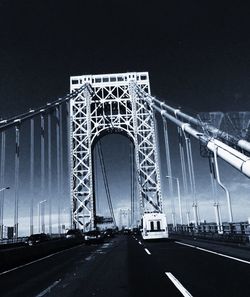 Illuminated bridge at night