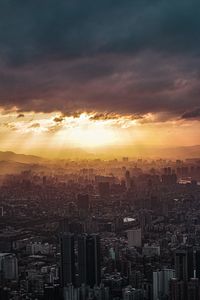 High angle view of city buildings against sky during sunset