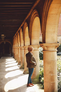 Full length of woman standing in corridor