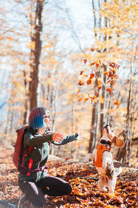 Rear view of woman with dog on field