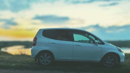 Close-up of toy car on road against sky