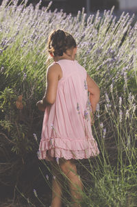 Side view of girl picking lavender at farm