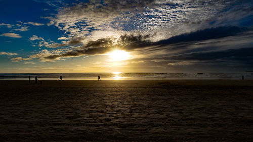 Scenic view of beach against sky during sunset