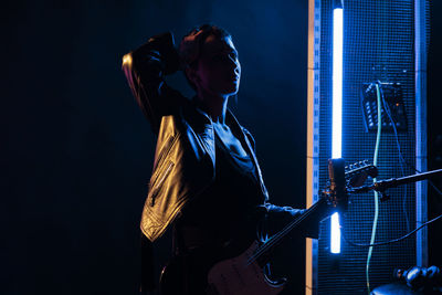 Rear view of woman playing guitar